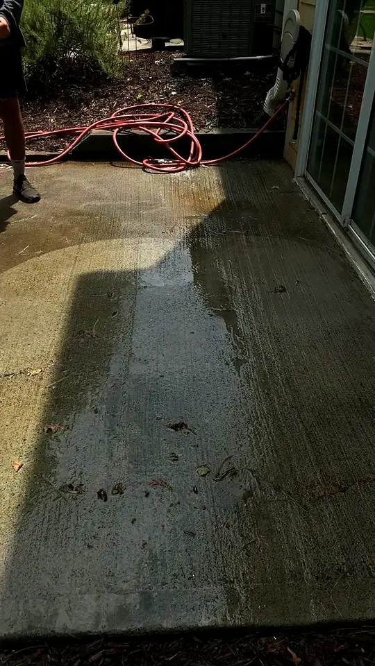 Clean stripes on a concrete driveway after a surface cleaner pass